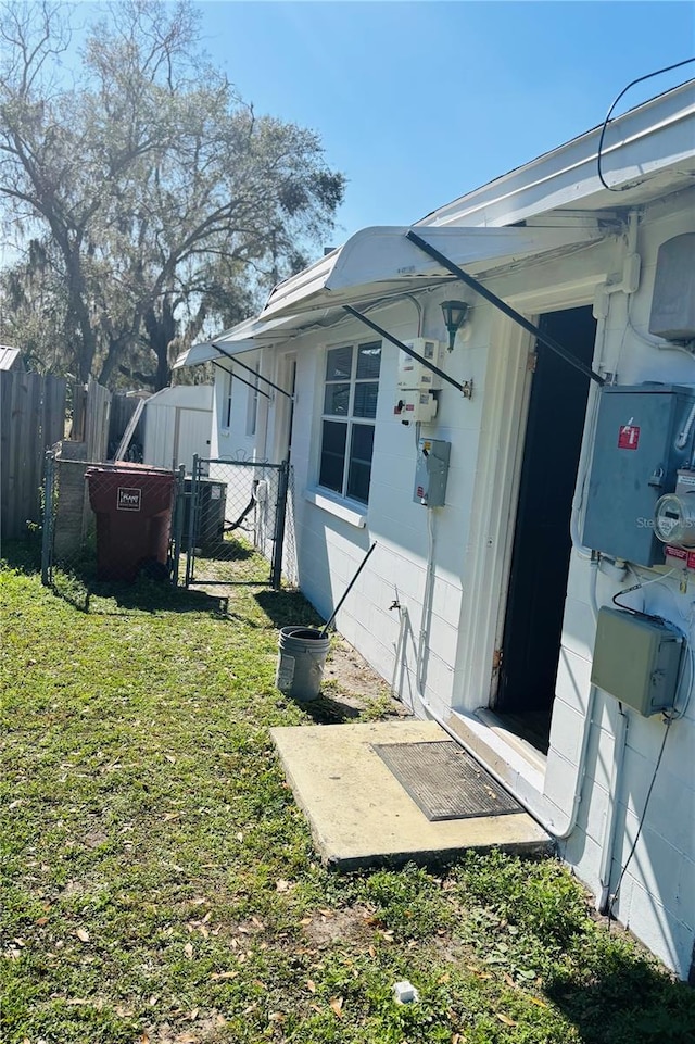 view of side of home with a lawn