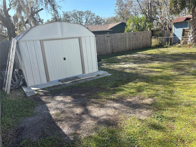 view of outbuilding with a yard