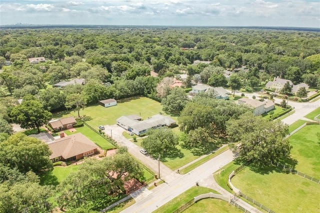 birds eye view of property featuring a residential view and a forest view