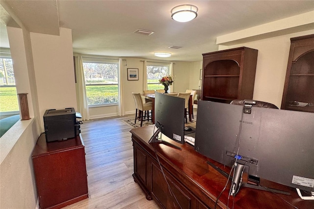 office area with baseboards, visible vents, and light wood-style floors