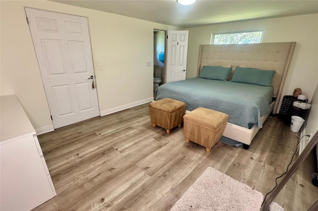 bedroom with baseboards and wood finished floors