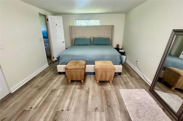 bedroom with wood finished floors and baseboards