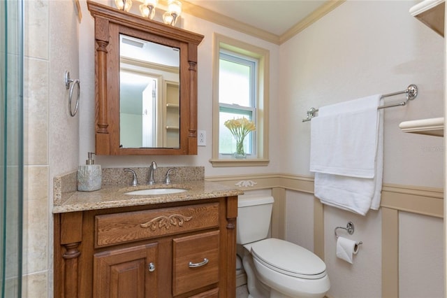 full bathroom featuring toilet, ornamental molding, and vanity