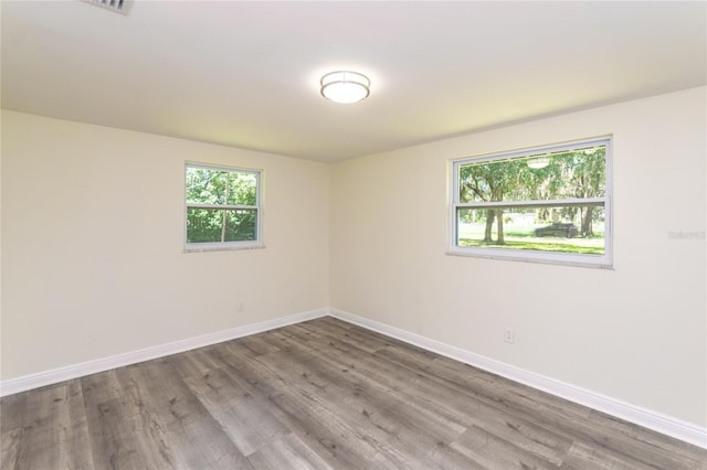 spare room featuring wood finished floors and baseboards