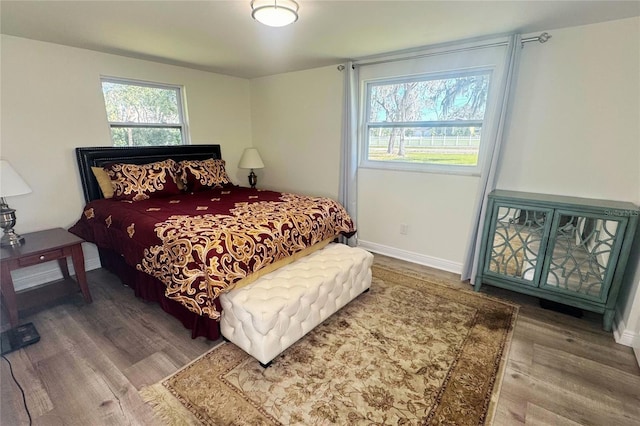 bedroom featuring baseboards and wood finished floors