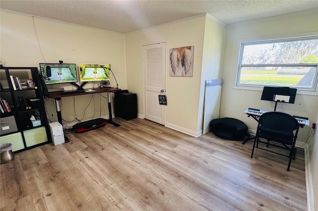 office area featuring a textured ceiling, light wood-style flooring, and baseboards