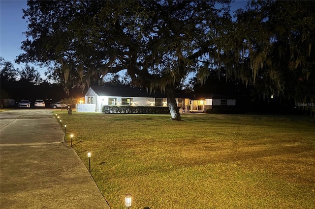 single story home with driveway and a front yard