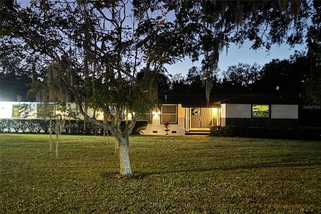 exterior space with a front yard and stucco siding