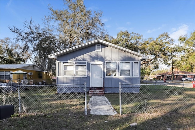 bungalow-style home with a front lawn