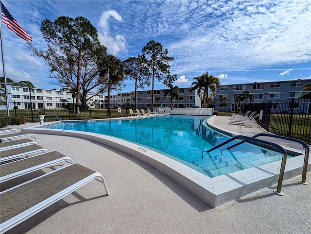 pool featuring fence and a patio