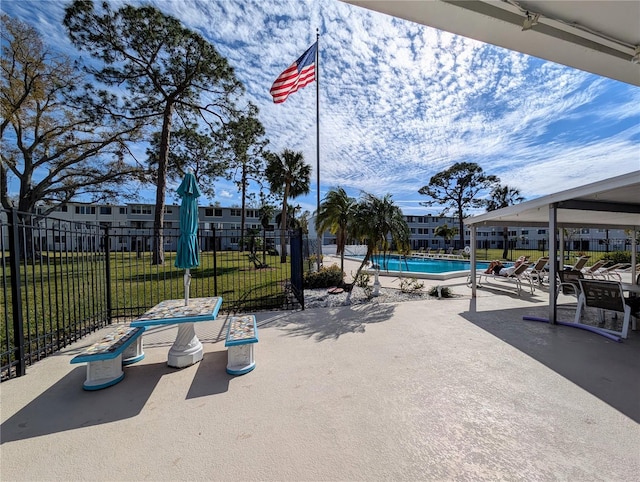 view of patio featuring fence and a community pool