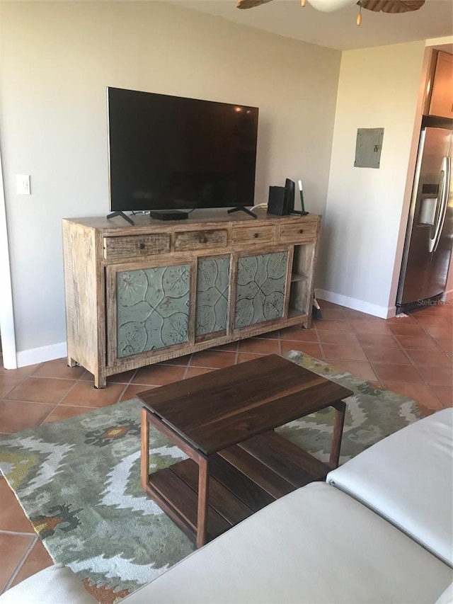 tiled living room with electric panel, ceiling fan, and baseboards