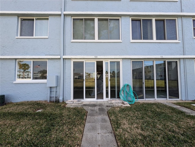 exterior space featuring a yard and stucco siding