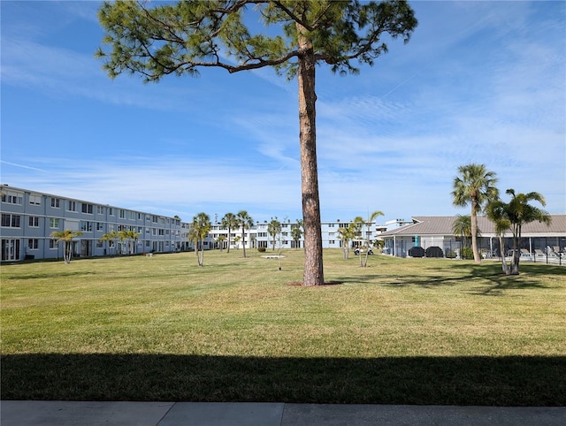 view of property's community with a lawn