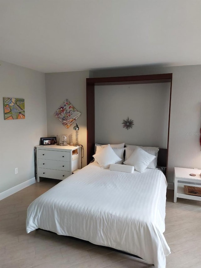 bedroom with light wood-type flooring