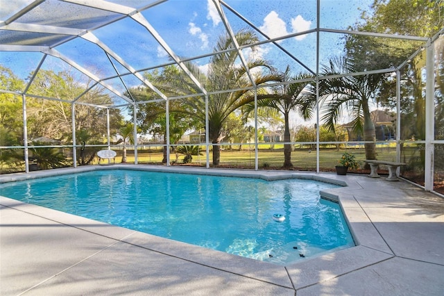 pool with a lanai and a patio area