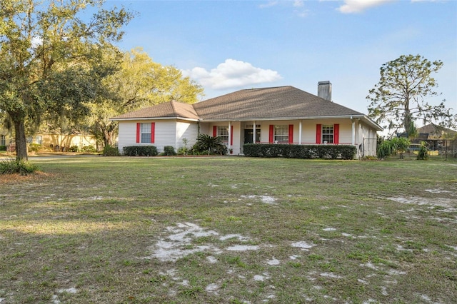 view of front of property featuring a chimney and a front yard