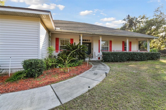 exterior space with a porch and a lawn