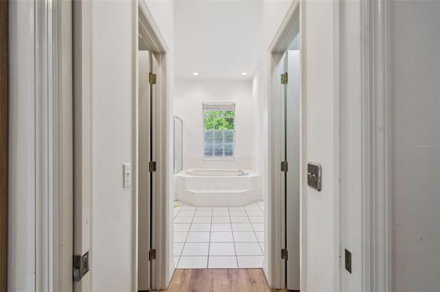 corridor featuring recessed lighting and light tile patterned floors