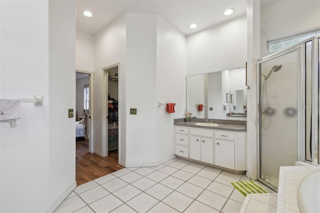 bathroom with a stall shower, recessed lighting, vanity, and tile patterned floors