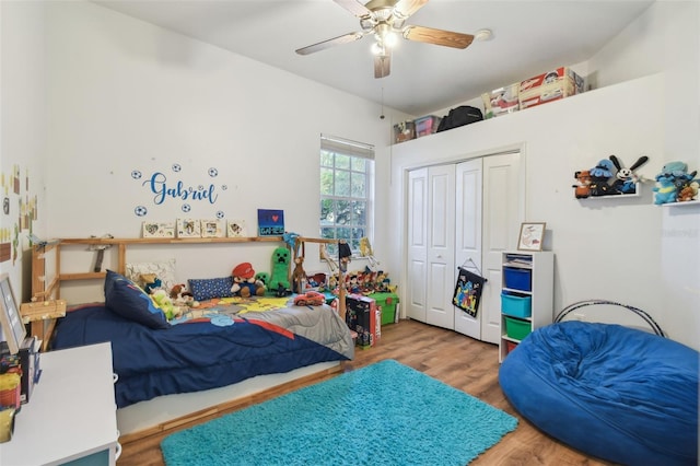 bedroom featuring a ceiling fan, a closet, and wood finished floors