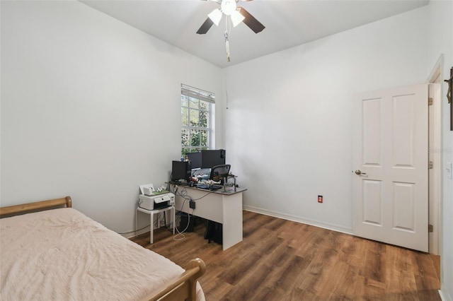 bedroom featuring ceiling fan, baseboards, and wood finished floors