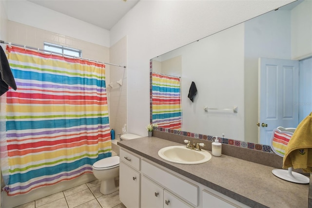 bathroom with toilet, vanity, and tile patterned floors