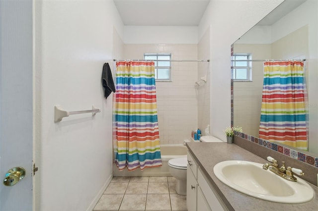 full bath featuring toilet, vanity, a wealth of natural light, and tile patterned floors