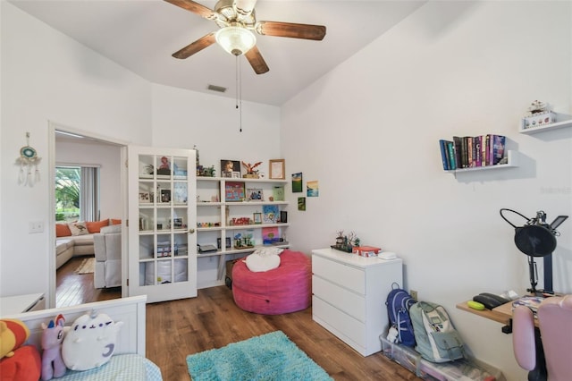 interior space featuring wood finished floors, visible vents, and a ceiling fan