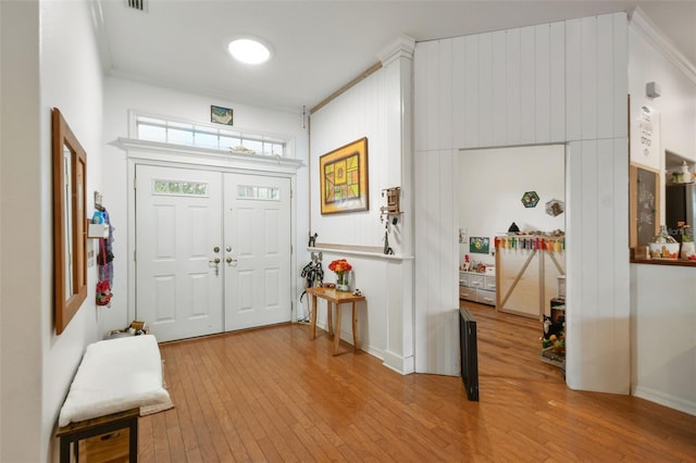 foyer with wood-type flooring and visible vents