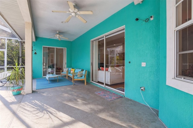 view of patio featuring a lanai and a ceiling fan