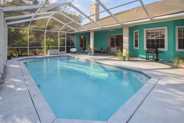 outdoor pool featuring a grill, a lanai, a patio area, and ceiling fan