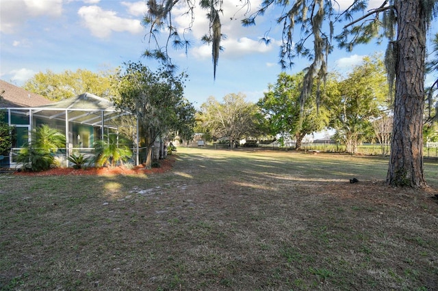 view of yard featuring glass enclosure