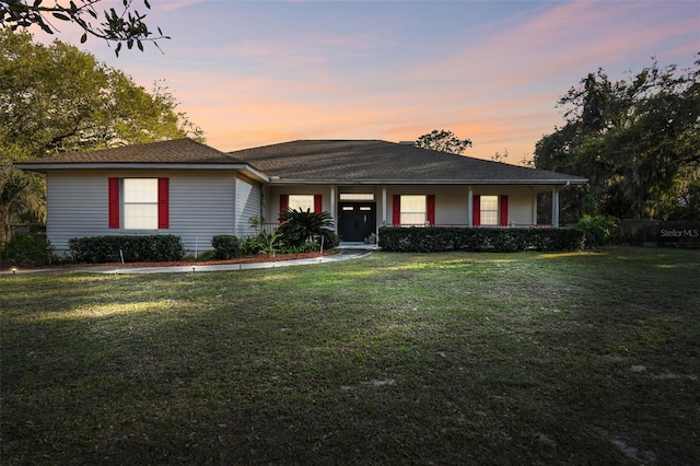 single story home featuring a yard