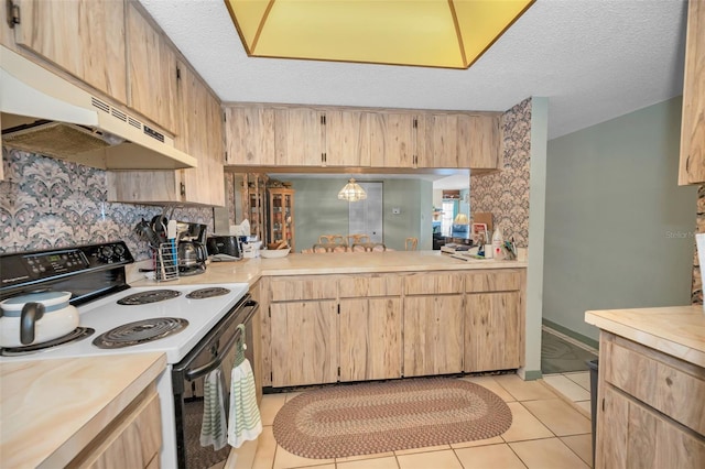 kitchen featuring electric stove, a textured ceiling, and light brown cabinets