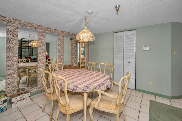 tiled dining space featuring a textured ceiling