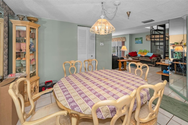 dining room featuring light tile patterned floors and a textured ceiling