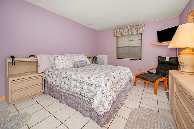 bedroom with light tile patterned floors