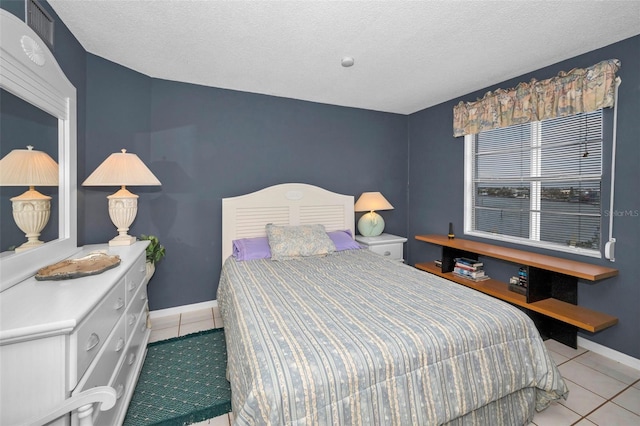 tiled bedroom featuring a textured ceiling