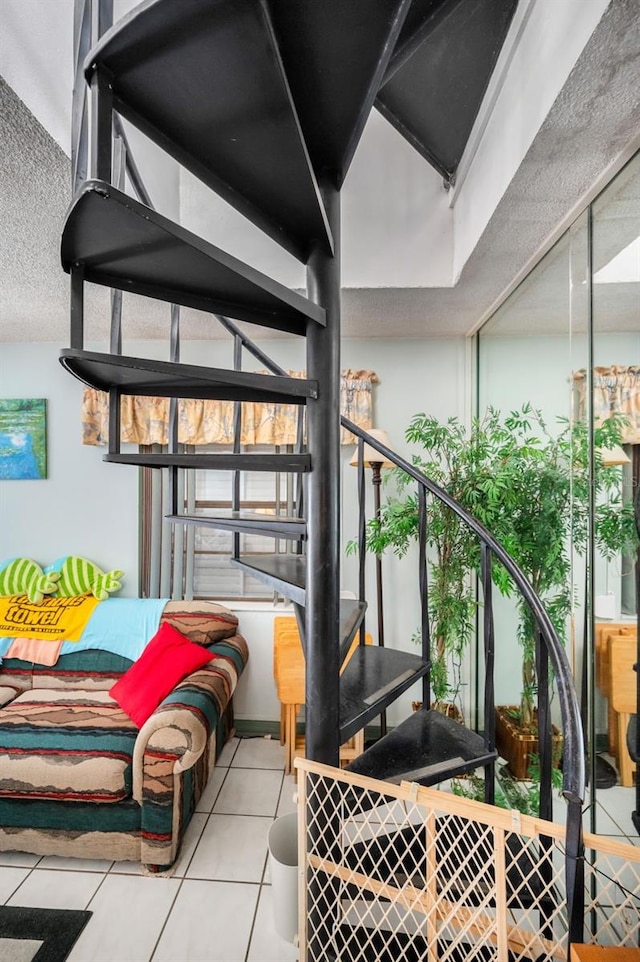 stairs featuring tile patterned flooring and a textured ceiling