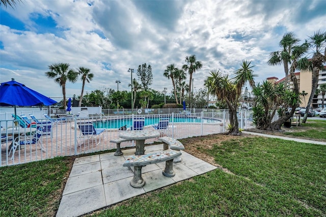 view of swimming pool with a yard and a patio