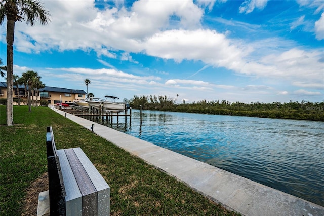 dock area with a water view and a lawn