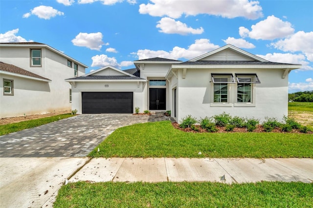 view of front of property featuring a garage and a front yard