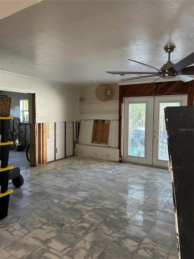 unfurnished living room with a textured ceiling and ceiling fan