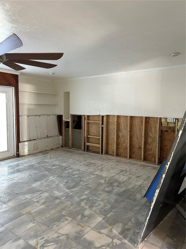 spare room with ornamental molding and ceiling fan