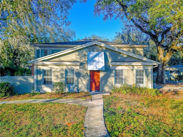 traditional-style home with a front lawn