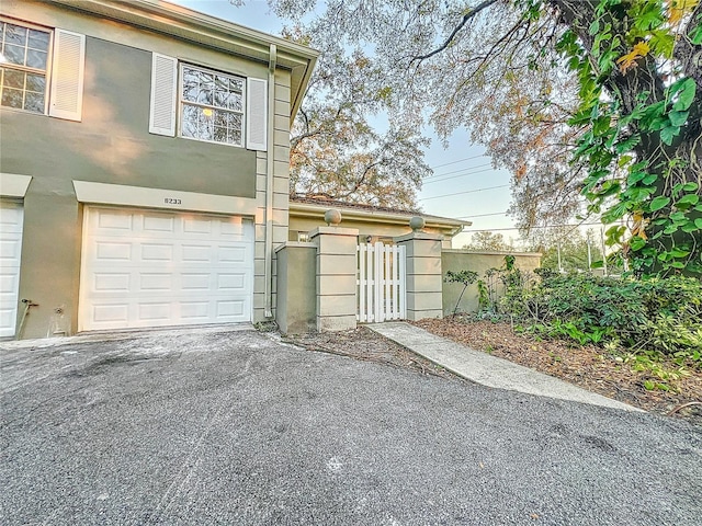 garage with aphalt driveway