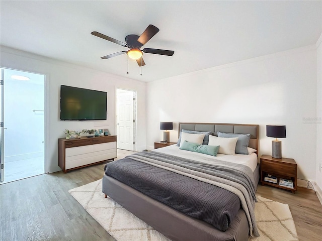 bedroom with ceiling fan, baseboards, and light wood-style floors