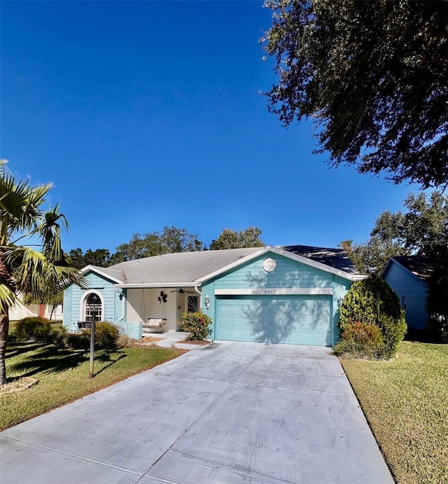 ranch-style house with a garage and a front lawn