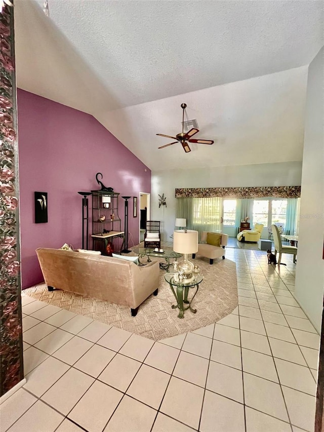 tiled living room featuring a textured ceiling, vaulted ceiling, and ceiling fan